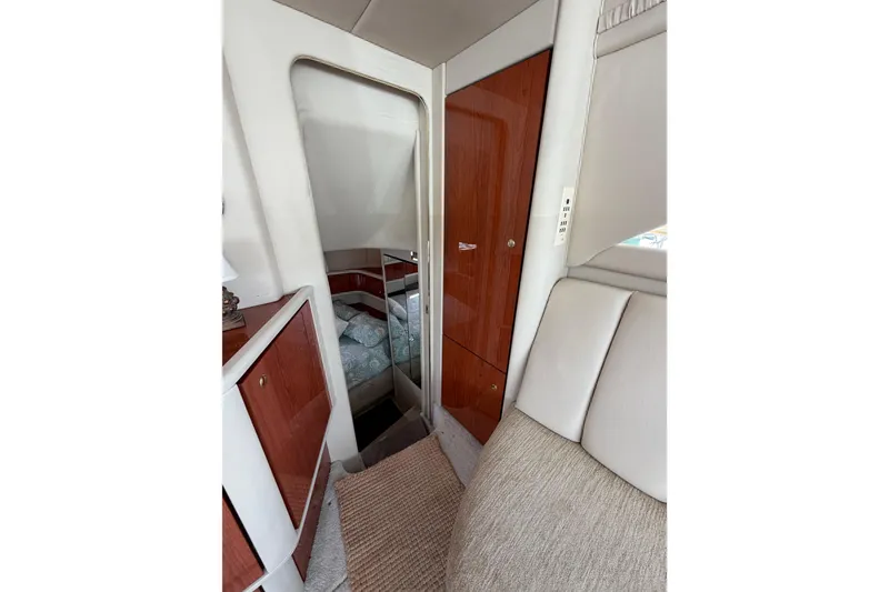 Slide: The Image of Interior of 1997 Sea Ray 370 Aft Cabin with wood paneling and cozy seating. - 29