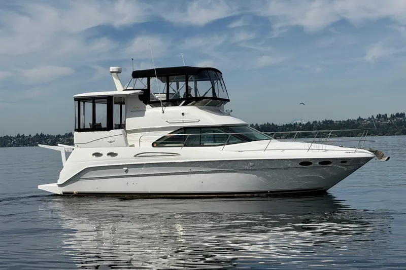 Slide: The Image of 1997 Sea Ray 370 Aft Cabin yacht on calm water under a blue sky. - 3