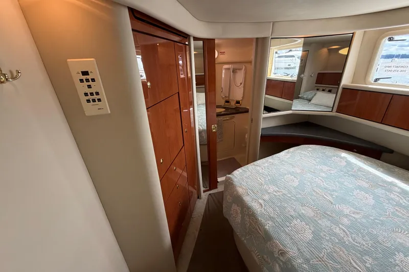 Slide: The Image of Luxurious 1997 Sea Ray 370 Aft Cabin interior with cozy bedroom and elegant wood finishes. - 31