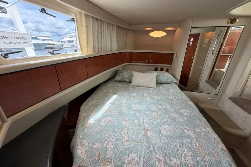 Slide: The Image of Cozy bedroom in 1997 Sea Ray 370 Aft Cabin yacht with nautical-themed bedding. - 32