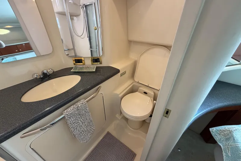 Slide: The Image of Bathroom interior of 1997 Sea Ray 370 Aft Cabin yacht, featuring sink and toilet. - 33