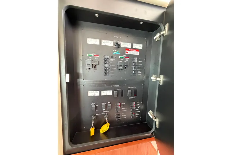 Slide: The Image of Electrical panel inside 1997 Sea Ray 370 Aft Cabin boat, featuring switches and gauges. - 35