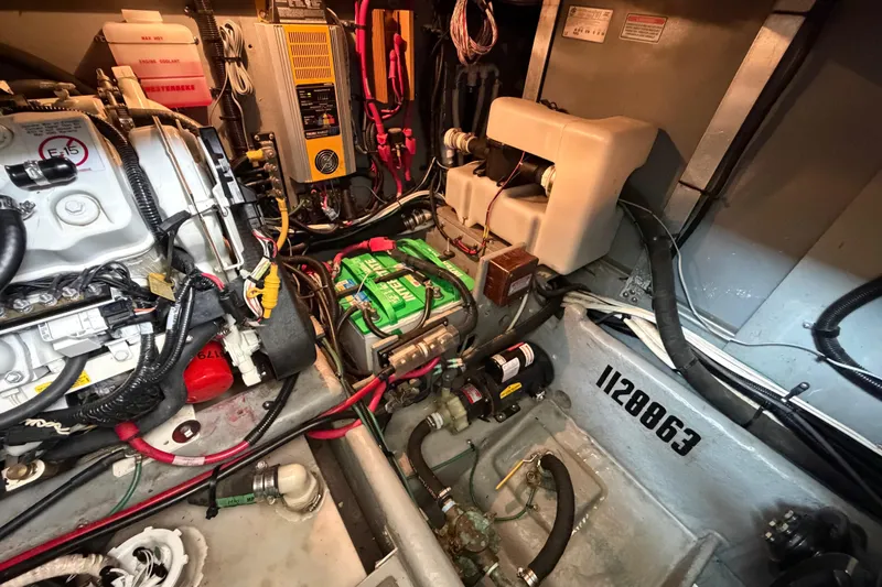 Slide: The Image of Engine room of a 1997 Sea Ray 370 Aft Cabin with visible machinery and wiring. - 38