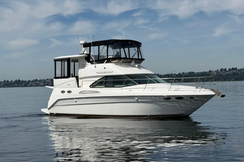 Slide: The Image of 1997 Sea Ray 370 Aft Cabin yacht on calm water under a clear sky. - 4