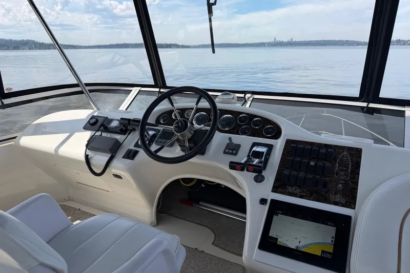 Slide: The Image of 1997 Sea Ray 370 Aft Cabin helm with steering wheel and navigation controls. - 5