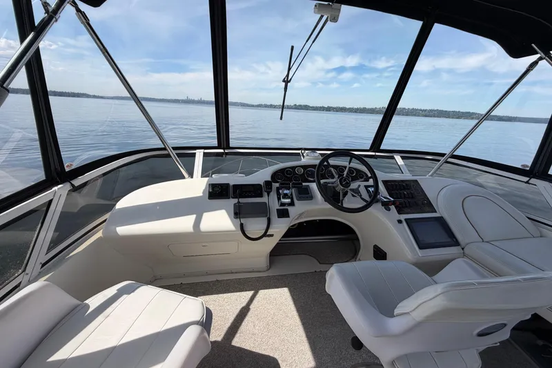 Slide: The Image of 1997 Sea Ray 370 Aft Cabin helm with panoramic water view. - 6