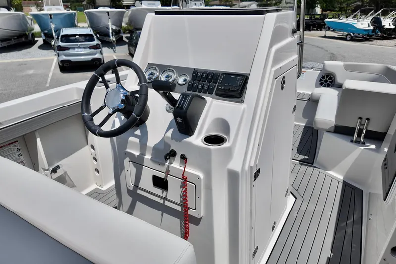 Slide: The Image of Steering console of 2026 Starcraft SVX 211 OB CC boat, featuring modern controls and seating. - 10
