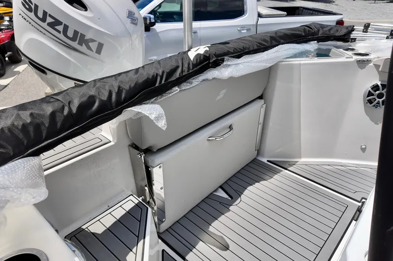 Slide: The Image of 2026 Starcraft SVX 211 OB CC boat interior with Suzuki engine, featuring sleek seating and storage. - 12