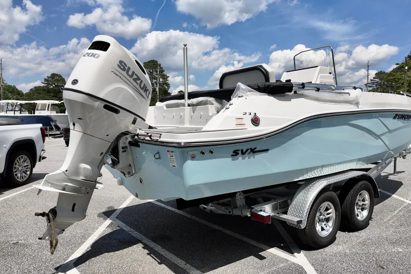 Slide: The Image of 2026 Starcraft SVX 211 OB CC boat with Suzuki engine on trailer. - 2