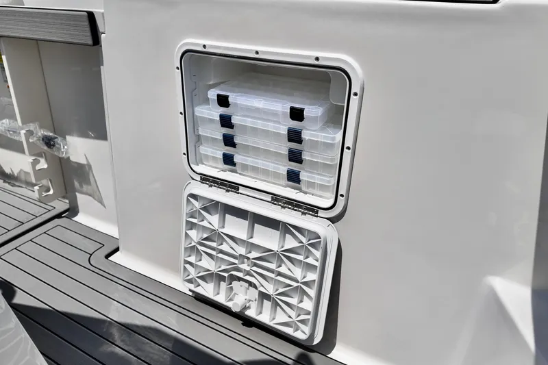Slide: The Image of Storage compartment on 2026 Starcraft SVX 211 OB CC boat with tackle boxes. - 6