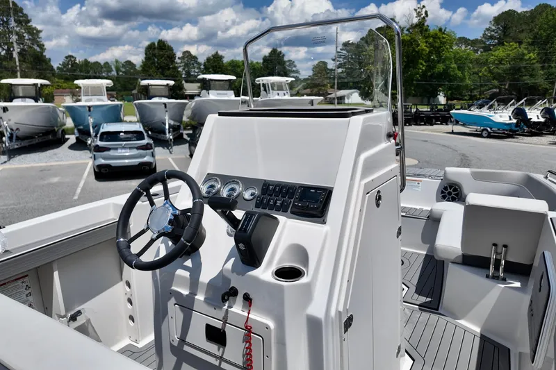 Slide: The Image of 2026 Starcraft SVX 211 OB CC boat interior with steering wheel and control panel. - 9