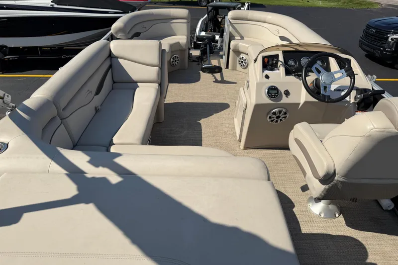 Slide: The Image of 2018 Bennington 21 SF boat interior with beige seating and steering console. - 16