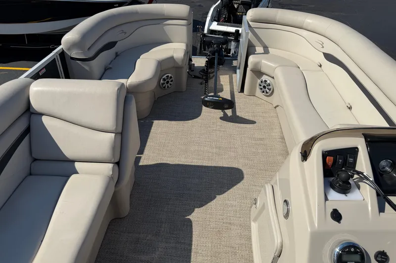 Slide: The Image of 2018 Bennington 21 SF pontoon boat interior with beige seating and control panel. - 17