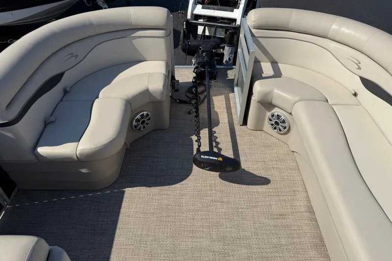 Slide: The Image of 2018 Bennington 21 SF boat interior with beige seating and Minn Kota trolling motor. - 18