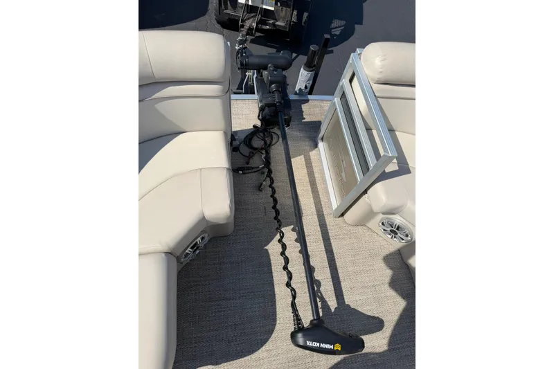 Slide: The Image of 2018 Bennington 21 SF boat interior with Minn Kota trolling motor and beige seating. - 19