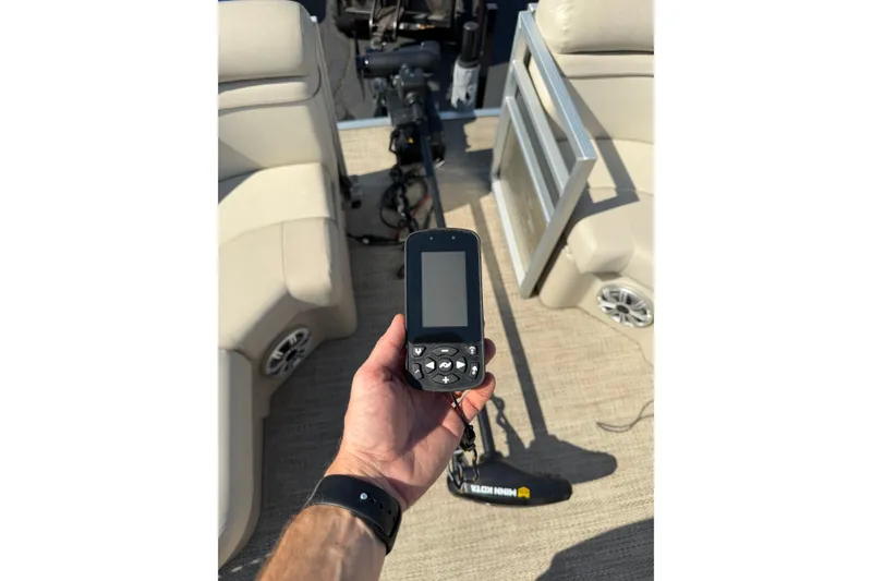 Slide: The Image of Hand holding a GPS device on a 2018 Bennington 21 SF boat deck. - 22