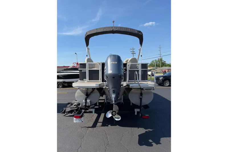 Slide: The Image of 2018 Bennington 21 SF pontoon boat with outboard motor, parked on asphalt. - 24