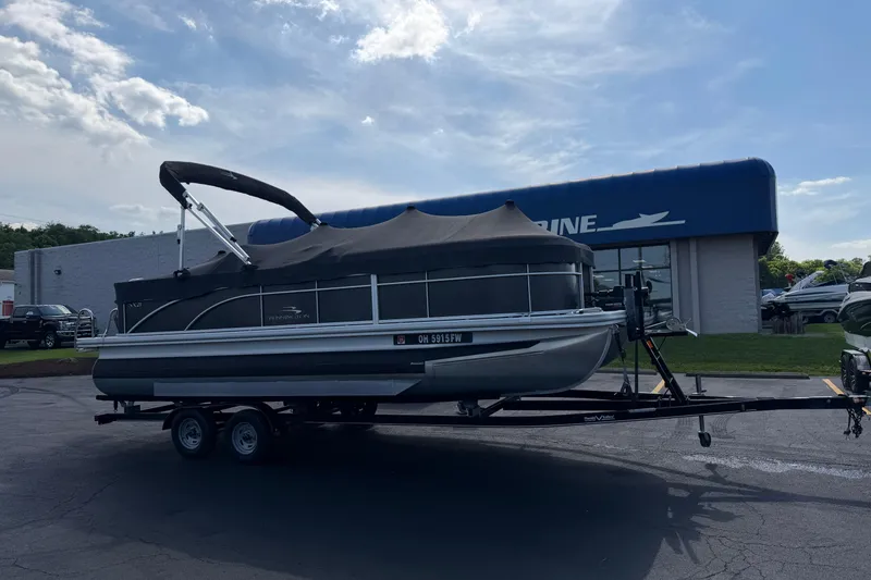 Slide: The Image of 2018 Bennington 21 SF pontoon boat on trailer outside dealership. - 25