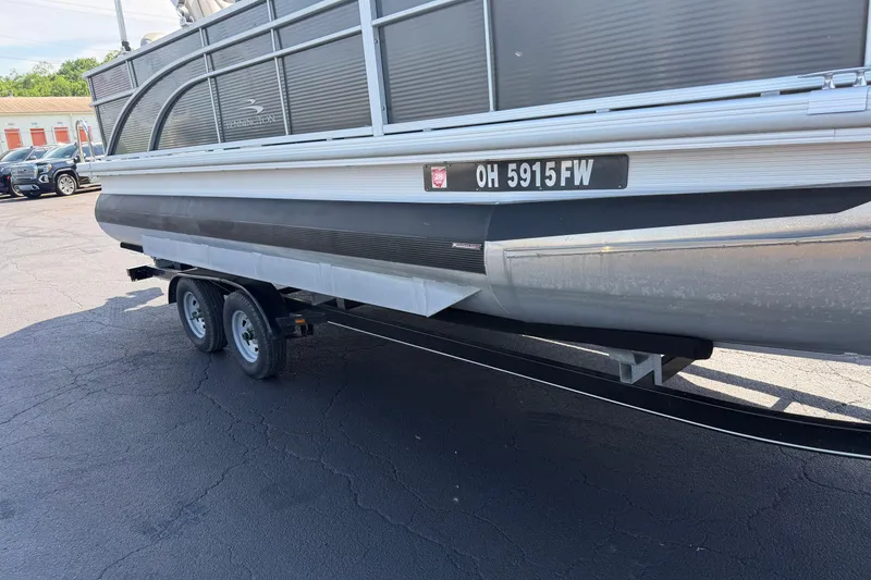 Slide: The Image of 2018 Bennington 21 SF pontoon boat on trailer, parked in a lot. - 26