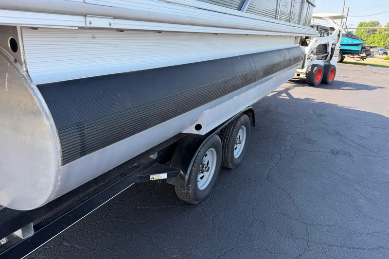 Slide: The Image of 2018 Bennington 21 SF pontoon boat on a trailer, parked on asphalt. - 27