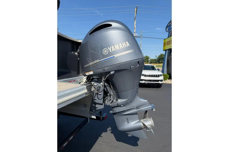 Slide: The Image of Yamaha outboard motor on a 2018 Bennington 21 SF boat, parked outdoors. - 29