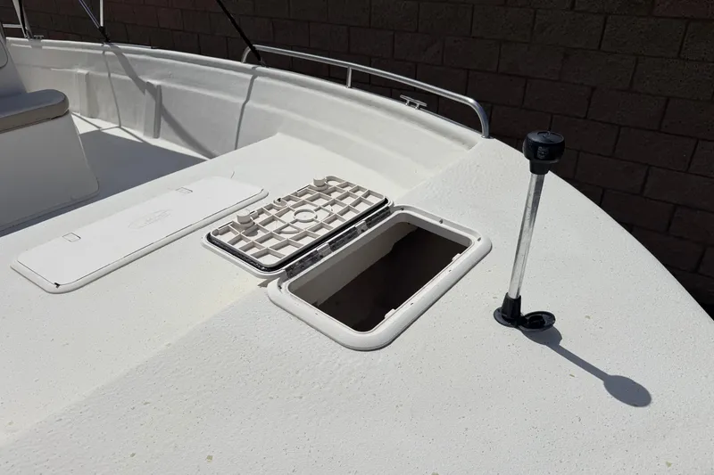 Slide: The Image of 2013 Carolina Skiff Sea Chaser 1950 RG deck with open hatch and railing. - 10