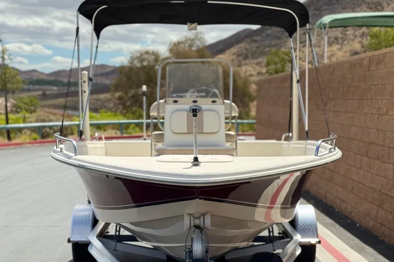Slide: The Image of 2013 Carolina Skiff Sea Chaser 1950 RG boat on trailer, parked outdoors. - 2