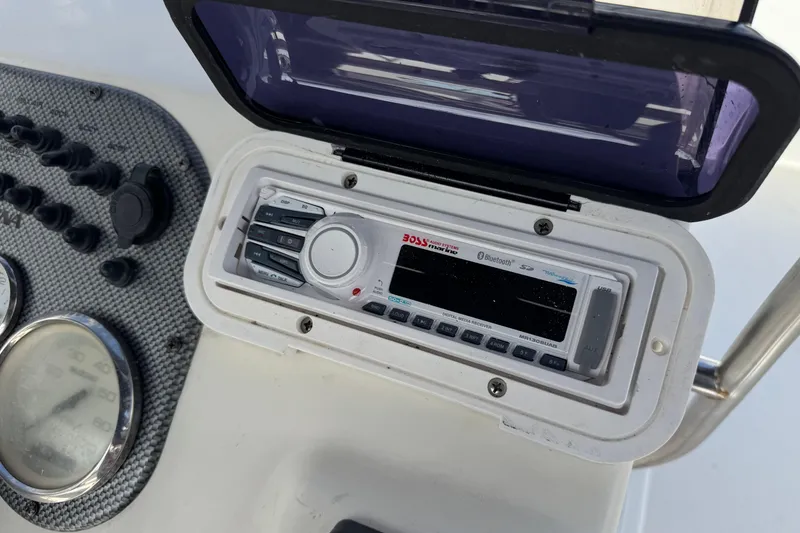 Slide: The Image of Boat dashboard featuring a Boss audio system on a 2013 Carolina Skiff Sea Chaser 1950 RG. - 21