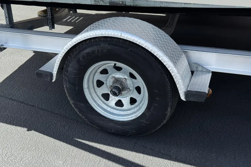 Slide: The Image of Trailer wheel of 2013 Carolina Skiff Sea Chaser 1950 RG on asphalt. - 23