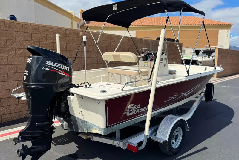 Slide: The Image of 2013 Carolina Skiff Sea Chaser 1950 RG boat with Suzuki outboard motor on trailer. - 5