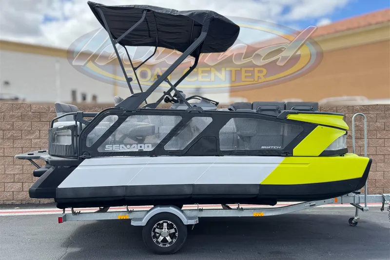 The Image of 2023 Sea-Doo Switch Cruise 18 on trailer, featuring vibrant yellow and black design. - 0