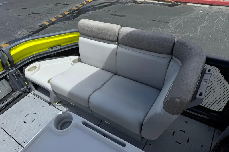 Slide: The Image of 2023 Sea-Doo Switch Cruise 18 interior seating with cup holders and modern design. - 13