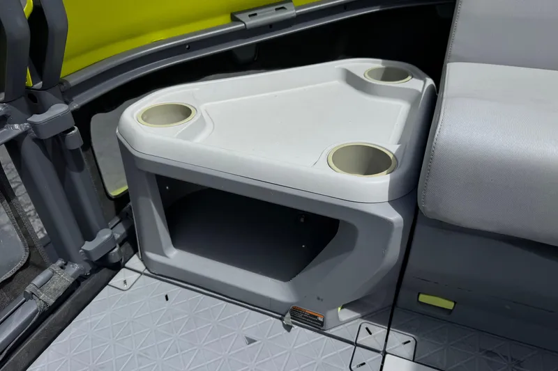 Slide: The Image of 2023 Sea-Doo Switch Cruise 18 interior with cup holders and storage compartment. - 14