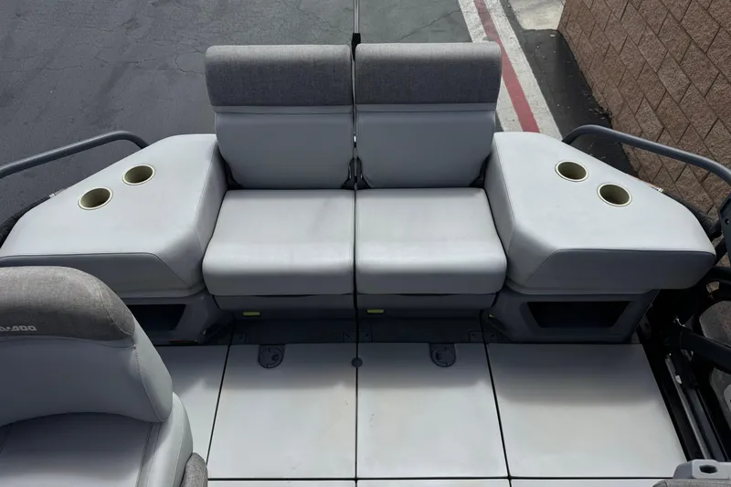 Slide: The Image of 2023 Sea-Doo Switch Cruise 18 interior seating with cup holders, showcasing comfort and design. - 17