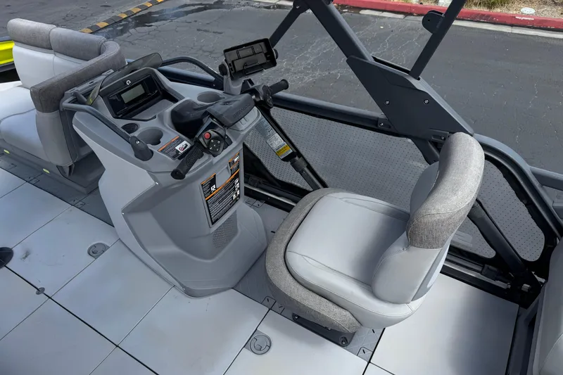 Slide: The Image of 2023 Sea-Doo Switch Cruise 18 cockpit with steering wheel and seating. - 20