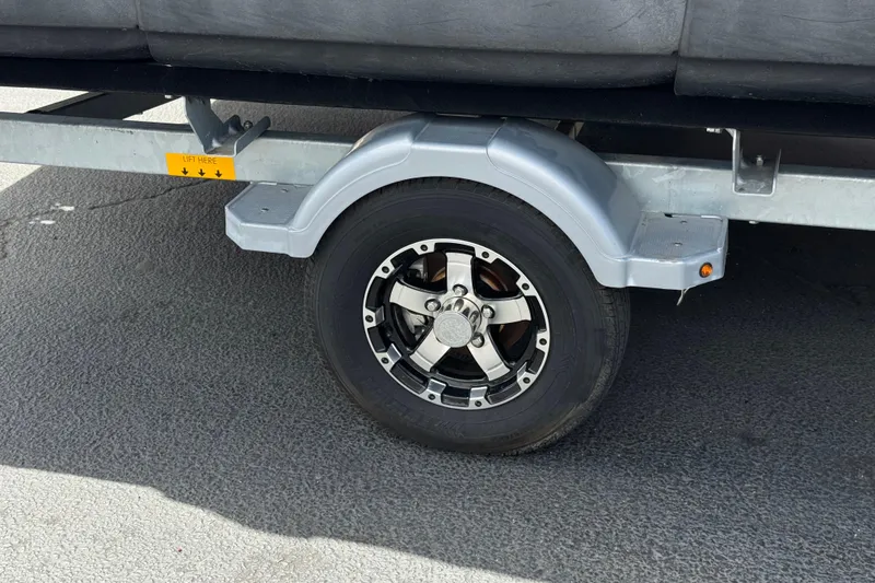 Slide: The Image of Trailer wheel of 2023 Sea-Doo Switch Cruise 18 on asphalt surface. - 24