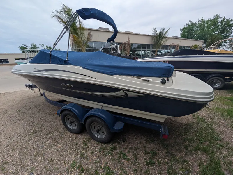 Slide: The Image of 2010 Sea Ray 205 Sport boat with blue cover on trailer. - 3