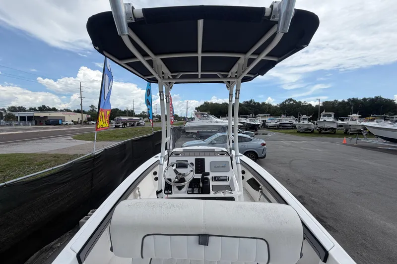 Slide: The Image of 2018 Yamaha Boats 190 FSH with T-top, parked in a dealership lot. - 11