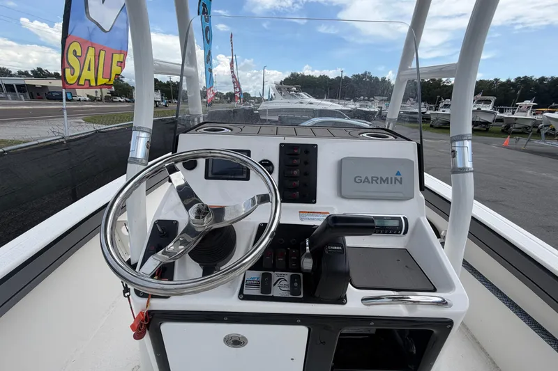 Slide: The Image of 2018 Yamaha Boats 190 FSH dashboard with Garmin navigation system, steering wheel, and controls. - 12