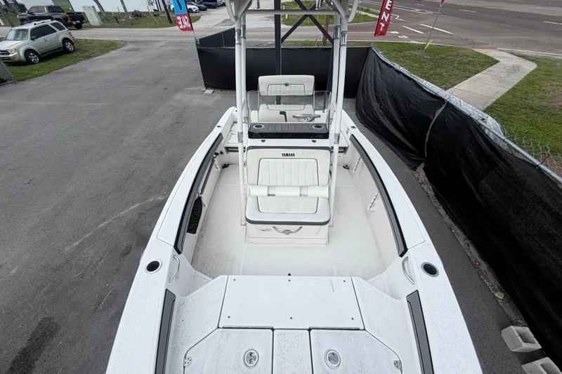 Slide: The Image of 2018 Yamaha Boats 190 FSH, white interior, parked on pavement, for sale. - 13