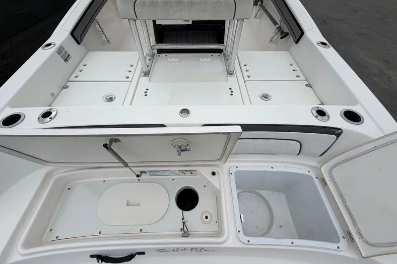 Slide: The Image of 2018 Yamaha Boats 190 FSH interior with storage compartments and seating area. - 15