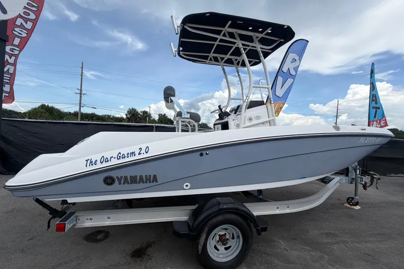 Slide: The Image of 2018 Yamaha Boats 190 FSH on trailer, side view with custom name "The Oar-Gasm 2.0". - 2