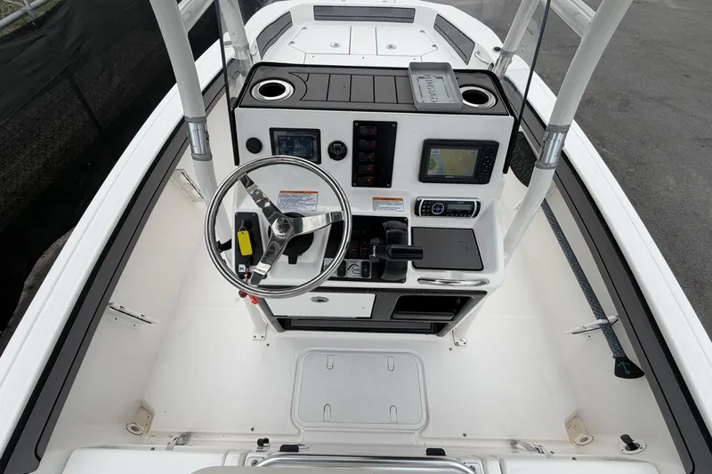 Slide: The Image of 2018 Yamaha Boats 190 FSH console with steering wheel and navigation equipment. - 23