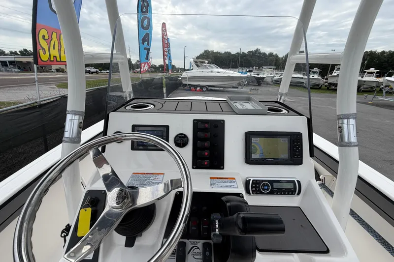 Slide: The Image of 2018 Yamaha Boats 190 FSH dashboard with steering wheel and navigation controls. - 24