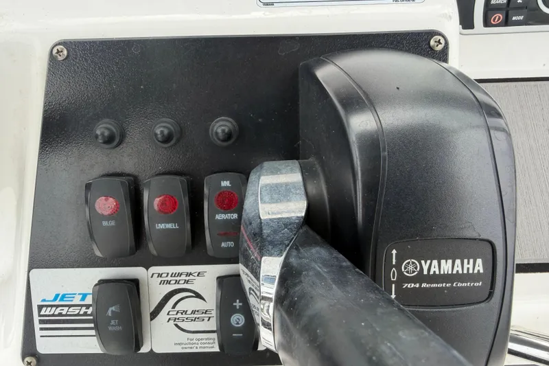 Slide: The Image of Control panel of 2018 Yamaha Boats 190 FSH with switches and throttle lever. - 28