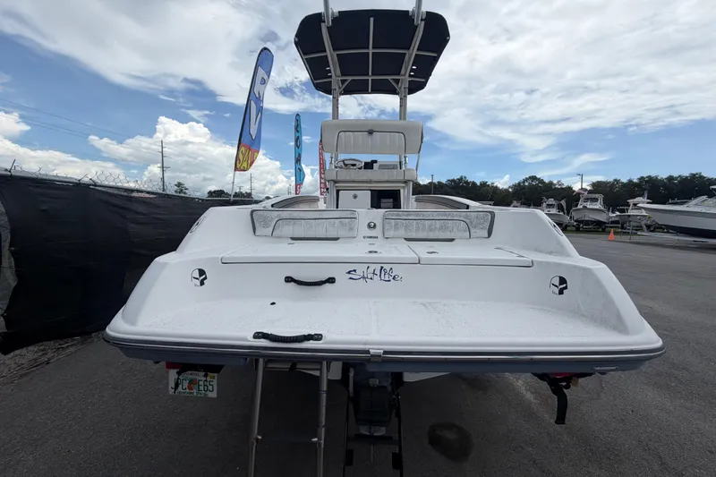 Slide: The Image of 2018 Yamaha Boats 190 FSH, rear view, displayed outdoors under a cloudy sky. - 3