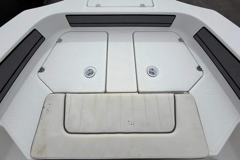 Slide: The Image of 2018 Yamaha Boats 190 FSH deck view, featuring storage compartments and seating. - 33