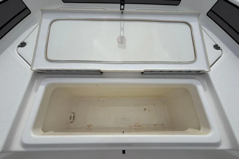 Slide: The Image of Open storage compartment on a 2018 Yamaha Boats 190 FSH. - 35