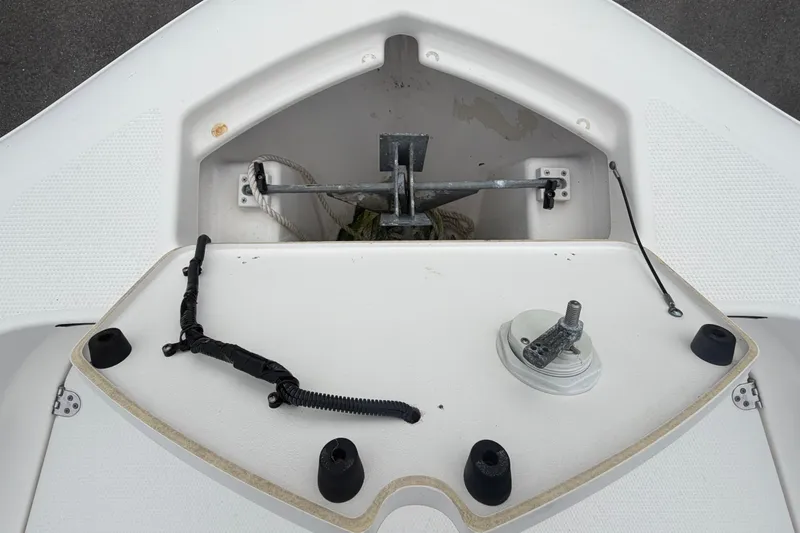 Slide: The Image of 2018 Yamaha Boats 190 FSH anchor compartment, top view, showcasing storage and hardware. - 39