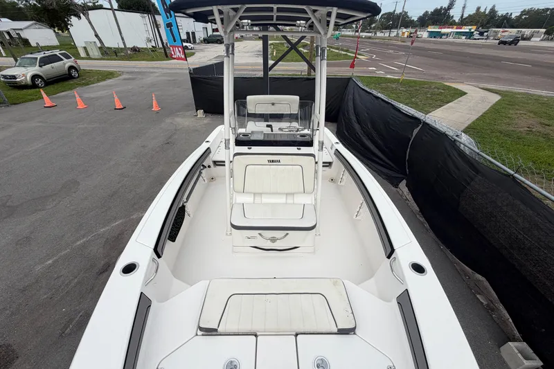 Slide: The Image of 2018 Yamaha Boats 190 FSH, white interior, parked outdoors near road and traffic cones. - 41